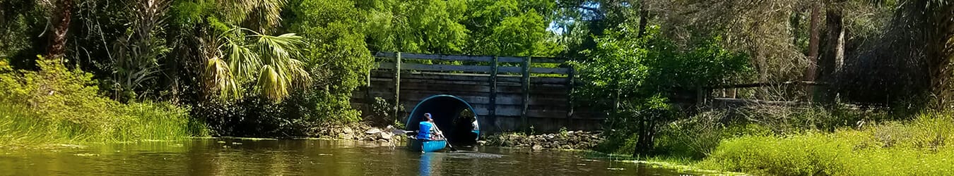 Riverbend Park Jupiter kayaking along the Loxahatchee River under a road